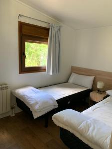 Postel nebo postele na pokoji v ubytování Panticosa Lodge