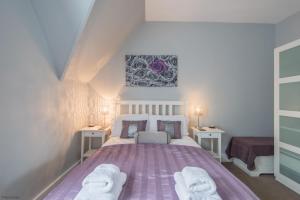 a bedroom with a purple bed with two night stands at Pitch Perfect by Bloom Stays in Canterbury