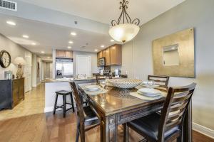 a dining room and kitchen with a table and chairs at Sterling Breeze #1702 by Book That Condo in Panama City Beach