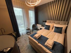 Łóżko lub łóżka w pokoju w obiekcie Hotel Sanova