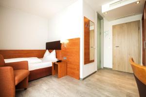 Postel nebo postele na pokoji v ubytování domus Hotel
