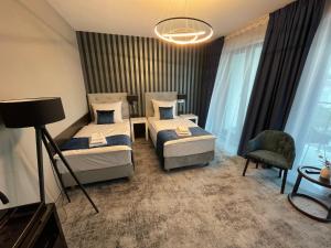 Łóżko lub łóżka w pokoju w obiekcie Hotel Sanova