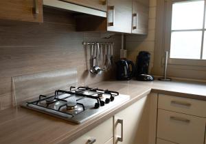a kitchen with a stove top on a counter at Chaletparc Krabbenkreek - Chalet 266 in Sint Annaland