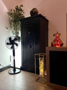 a room with a black cabinet and a fan at LA CASITA in Zamora