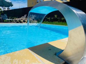 a water fountain in front of a swimming pool at VilleLay Alojamento VNG in Vila Nova de Gaia