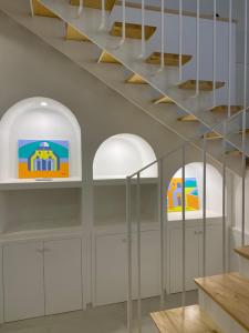 a room with white cabinets and two white shelves at Zaras 11 in Ischia