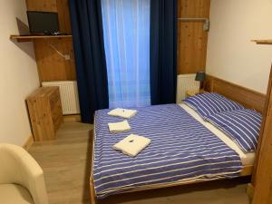 Postel nebo postele na pokoji v ubytování Penzion a Restaurace Vyhlídka