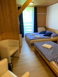 Postel nebo postele na pokoji v ubytování Penzion a Restaurace Vyhlídka