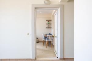 a hallway with a door leading to a dining room at Kalypso Apartment Ierapetra in Ierapetra