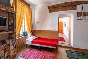 a bedroom with a red bed and a mirror at Historical Center of Lviv in Lviv