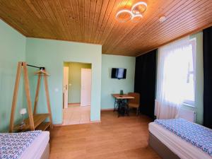 1 Schlafzimmer mit 2 Betten und Holzdecke in der Unterkunft Hostel in Böhlen