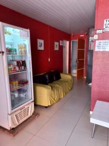 a room with a refrigerator and a bed in it at Pousada Kaka in Teresina
