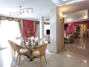 a dining room with a glass table and chairs at Aguamarina in Peñíscola
