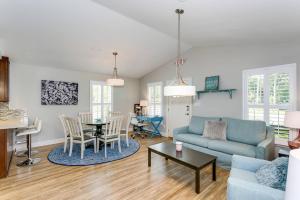 a living room with a blue couch and a table at Reus Retreat in Pensacola