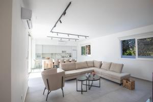 a living room with a couch and a table at Kube Luxury Villas in Ayia Napa