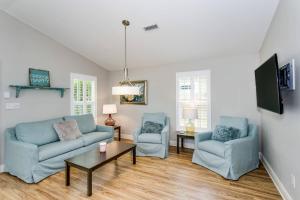 a living room with two chairs and a couch and a table at Reus Retreat in Pensacola