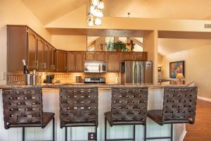a kitchen with a large counter with stools at MySedonaGold, The Place to Chill in Sedona in Sedona