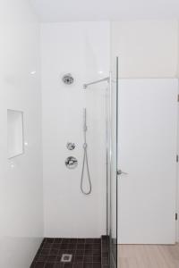 
a bathroom with a shower, sink, and toilet at Addison Lee Cayman Villa in George Town
