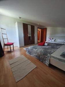 a bedroom with a bed and a chair and a ladder at Bougenville in Kampor