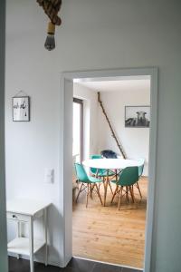 a dining room with a table and chairs at Ferienwohnung-Heinke-Urlaub-in-Tating-nahe-St-Peter-Ording in Tating