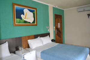 Ένα ή περισσότερα κρεβάτια σε δωμάτιο στο Hotel Poloni