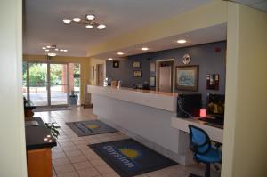 a restaurant with a reception counter and a blue chair at Days Inn by Wyndham Capitol Reef in Torrey