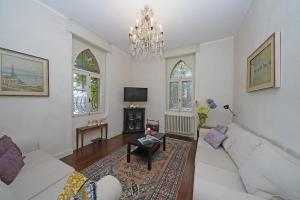 sala de estar con sofá blanco y lámpara de araña en Villa Maria, en Saló