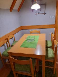 a dining room with a wooden table and chairs at Holiday home Milenkovic in Vrnjačka Banja