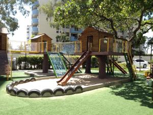 a playground with a slide in a park at Ap. Resort Recreio dos Bandeirantes in Rio de Janeiro