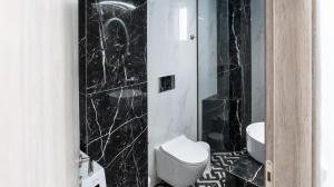 a black marble bathroom with a toilet and a sink at Mythic Villas in Epanomi +30 photos