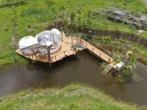 
a small boat floating on top of a body of water at Green Land Bubble Glamping in Cabarete
