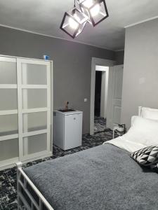 a bedroom with a large bed and a white cabinet at Vila 4 Anotimpuri in Moieciu de Sus