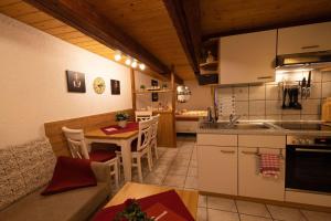 a kitchen with a table and a dining room at Ferienhof-Gerda-Ferienwohnung-Storchennest in Oberkirnach