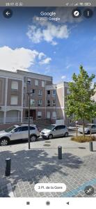two cars parked in a parking lot in front of a building at Aéroport Roissy CDG - Parc Astérix - Parc des expositions in Louvres