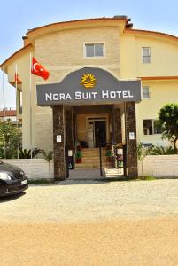 a nedera stuff hotel with a car parked in front at Nora Suit Hotel in Side