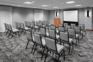 a room with a bunch of chairs and a screen at Hyatt Place Boston/Braintree in Braintree