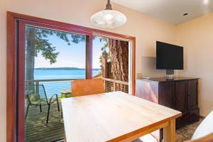 a dining room with a table and a view of the water at Sound View in South Beach