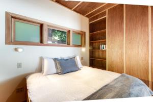 a small bedroom with a bed and wooden cabinets at Sound View in South Beach