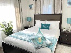 a bedroom with a bed with a tray with a candle on it at Water Canal Villa Salgado in Bellmore