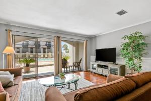 a living room with a couch and a tv at Dune Villas 7A in Santa Rosa Beach