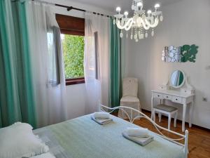 a bedroom with a bed and a table and a chandelier at Apartment Lorenzo in Trogir