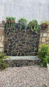 a stone retaining wall with potted plants on it at Estancia Buen Dia in Ciudad Valles