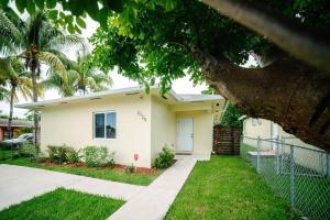 ein weißes Haus mit einem Baum davor in der Unterkunft New house on the block near Miami Airport. in Miami