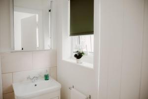 a bathroom with a toilet and a sink and a window at 1 Chantry Cottage in Tunstall +19 photos