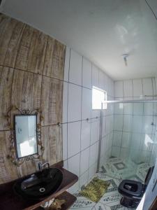 a bathroom with a sink and a mirror on the wall at Casa Da Cléo Carrancas in Carrancas
