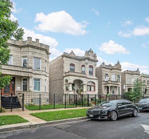 a black car parked in front of a building at Spacious 5-BR Apt next to transit Free Parking in Chicago