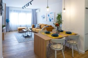 a kitchen and living room with a table and chairs at Akiton Apartment in Belgrade