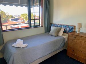 a bedroom with a bed with a large window at 3 Bedroom Apartment, Kaikoura in Kaikoura