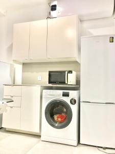 a kitchen with a washing machine and a microwave at Frank's House & Happy BELEM in Lisbon