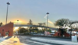 a bridge over a city street with the sun setting at Frank's House & Happy BELEM in Lisbon